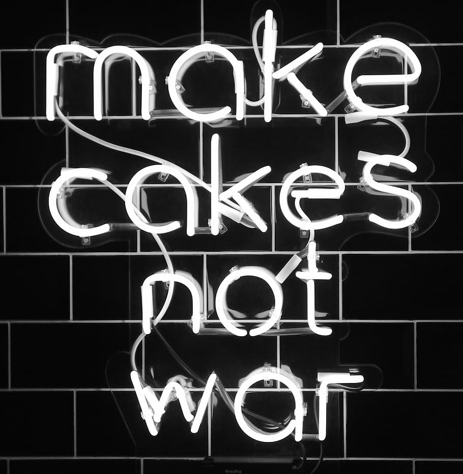 white make cakes not war neon sign, make cakes not war neon signage on black wall
