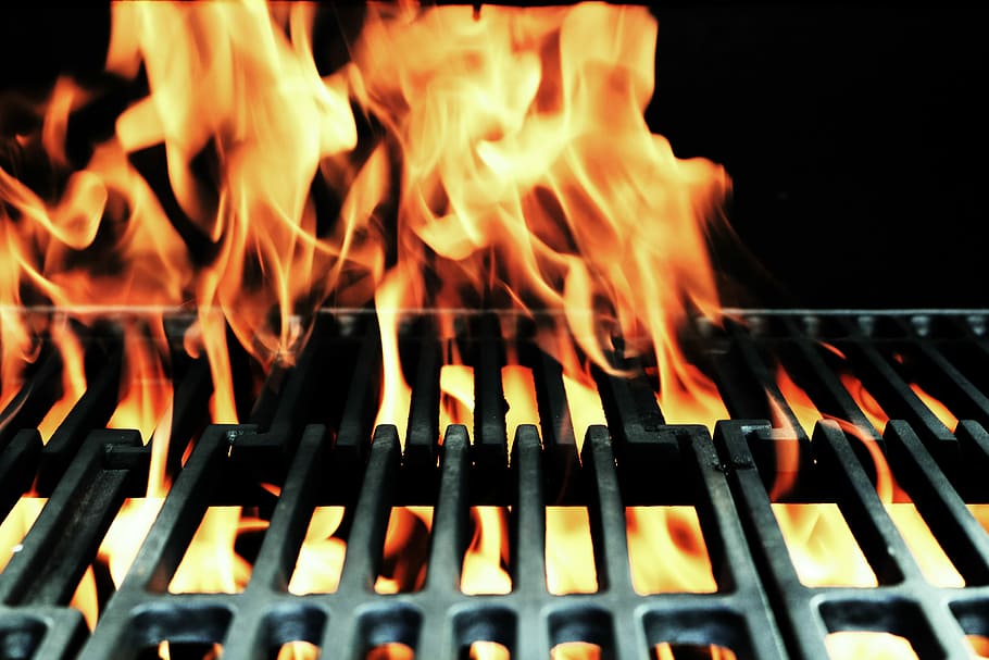 fire on metal, close up photo of burning grill, grid, grate, flame