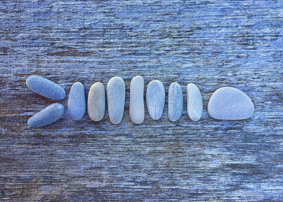 close up photo lined stones on brown surface, rock, art, craft HD wallpaper