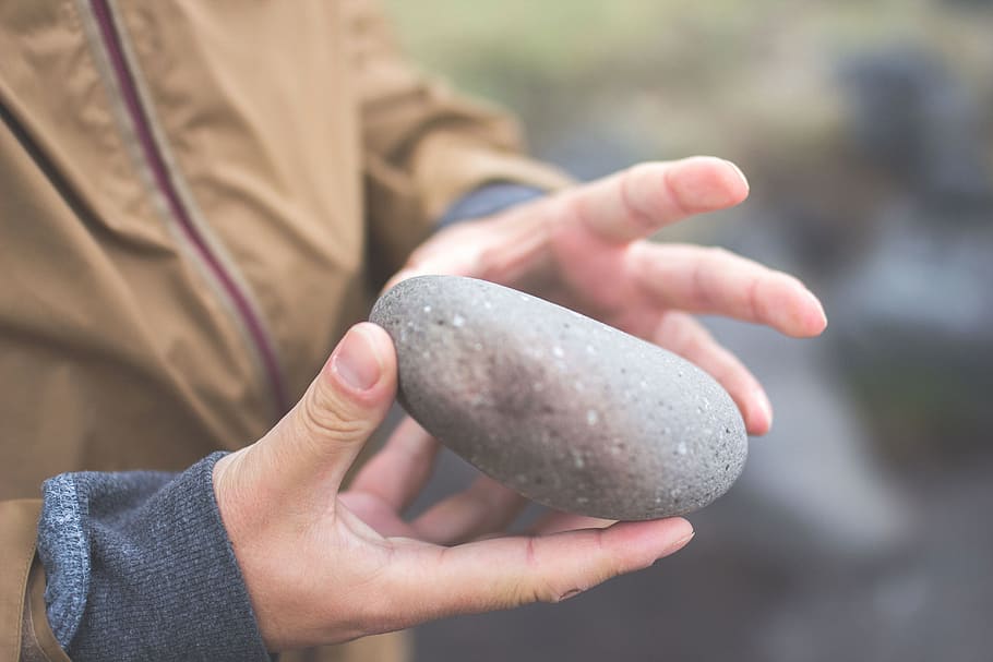 close-up photography of person holding gray stone, hands, rock HD wallpaper