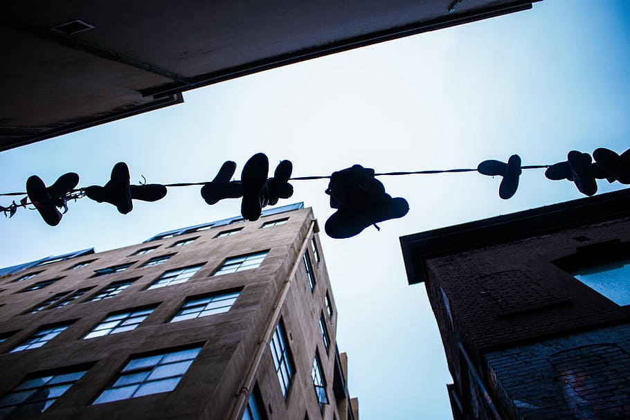 low-angle photo of hanged shoes on sting during daytime, silhouette photo of a footwear lot HD wallpaper
