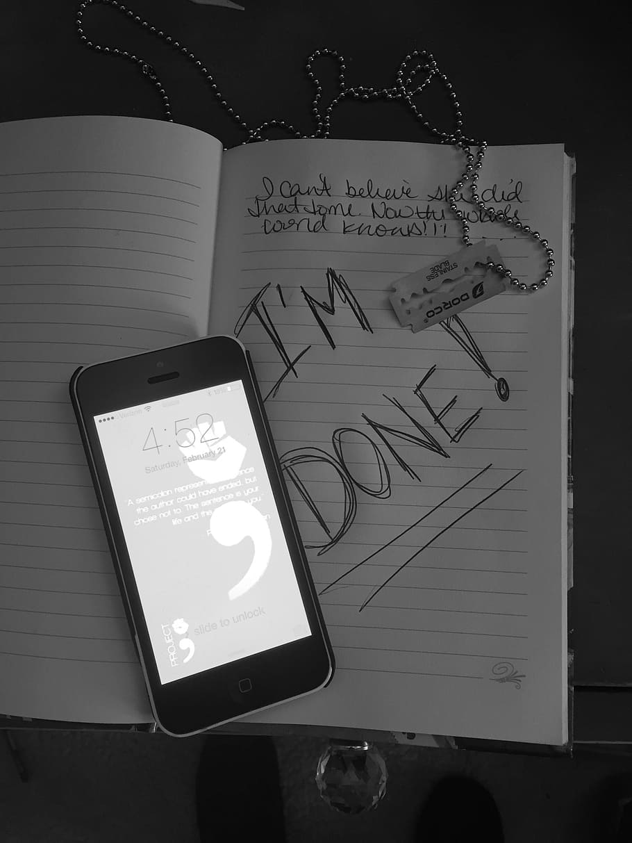 turned-on iPhone 5 on opened book with i'm done text, cutting, HD wallpaper