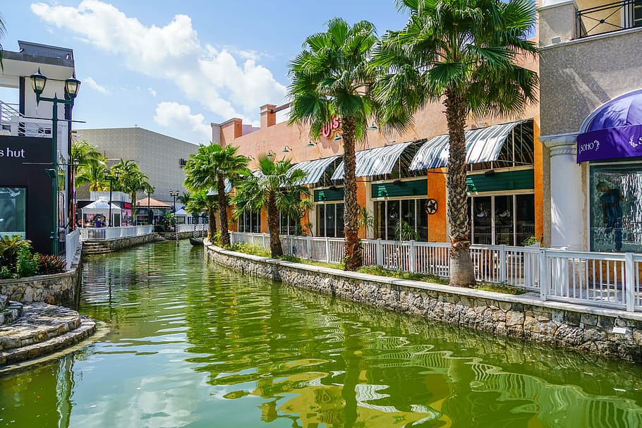 calm body of water beside brown concrete building, cancun, mexico, HD wallpaper