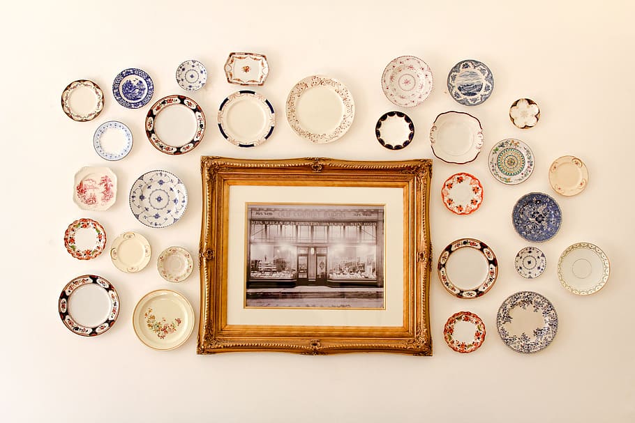photo frame near assorted-color ceramic dishes, framed photo surrounded by plates HD wallpaper