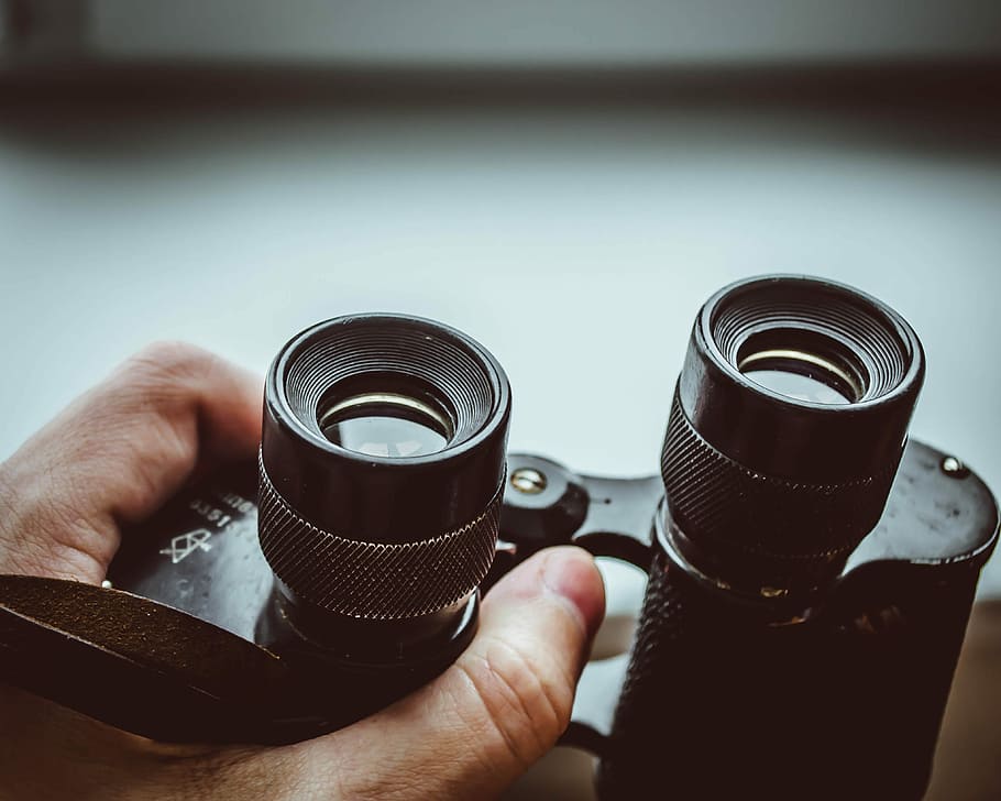 black binoculars, lens, view, hand, human hand, holding, human body part HD wallpaper