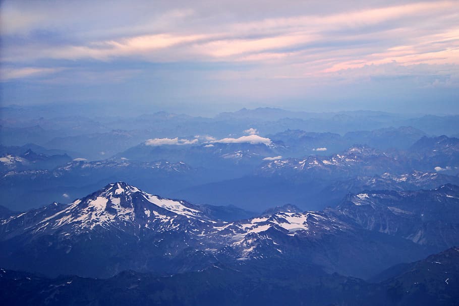 aerial photo of rocky mountains, aerial photography of snow-capped mountain range during daytime HD wallpaper