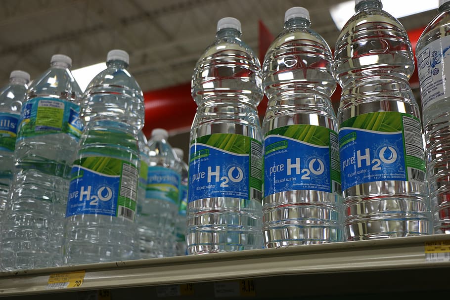 selective focus photo of H2O bottled water display on white surface HD wallpaper