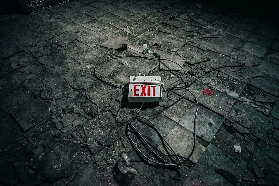 grey exit sign board on grey pavement, white exit signage with gray cords on gray tiled pavement HD wallpaper