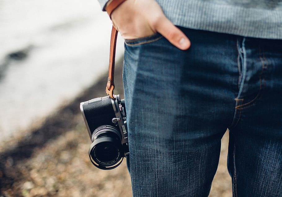 person holding black and gray DSLR camera, person hand in pocket HD wallpaper