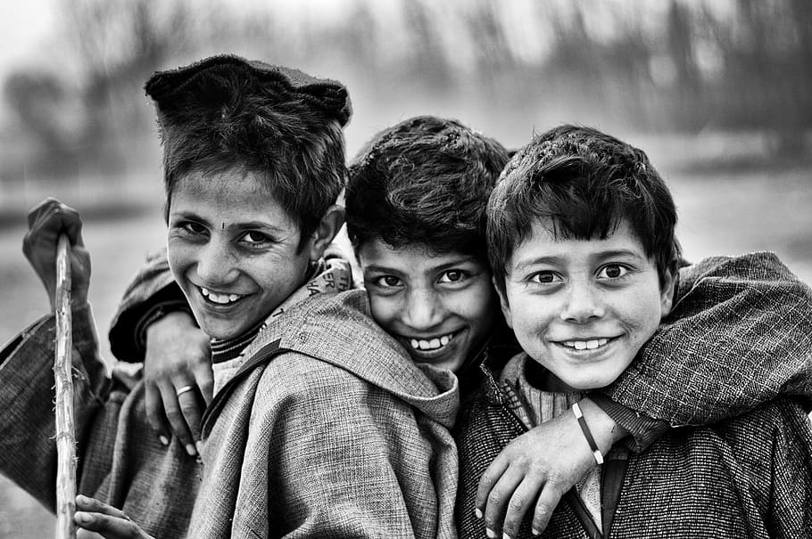 grayscale photo of three boys smiling, climate, black and white