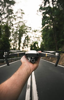 selective focus photography of gray DJI Mavic Pro, focus photo of person holding DJI Mavic Pro drone HD wallpaper