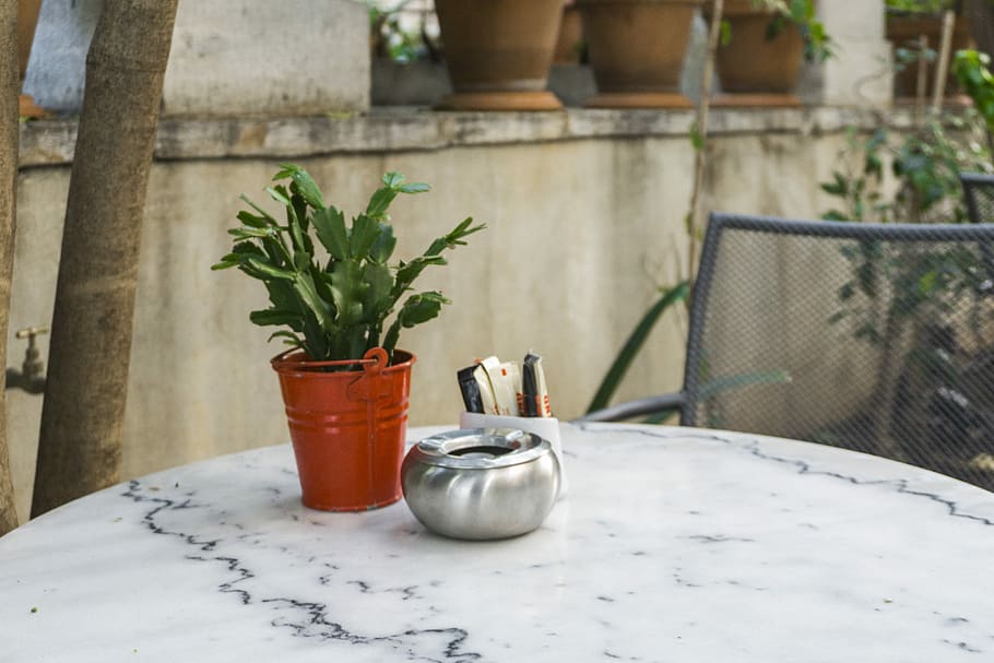 green leafed in brown pot on grey table, green leafed plant in brown tin bucket on tale HD wallpaper