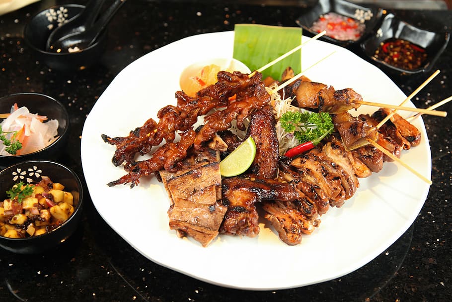 plate of grilled barbecues, street food barbecue, pork intestine