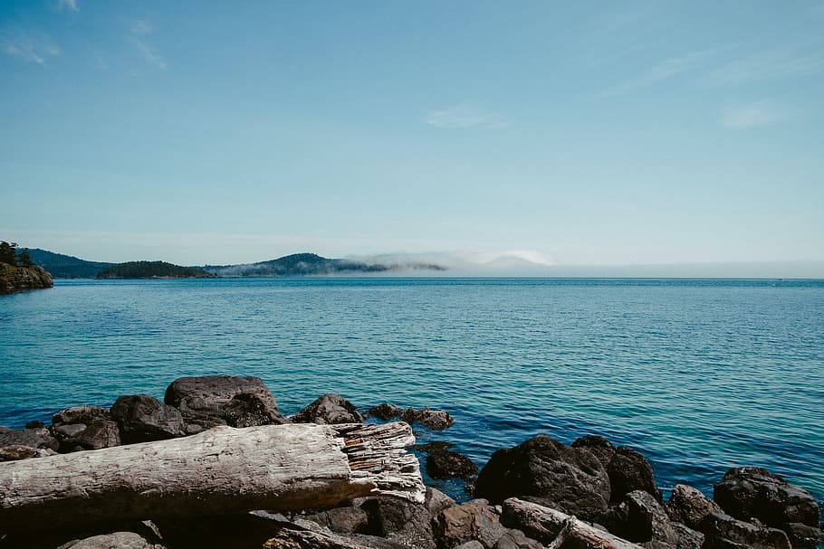 ocean, tide, stones, beach, water, current, breakwater, sky HD wallpaper