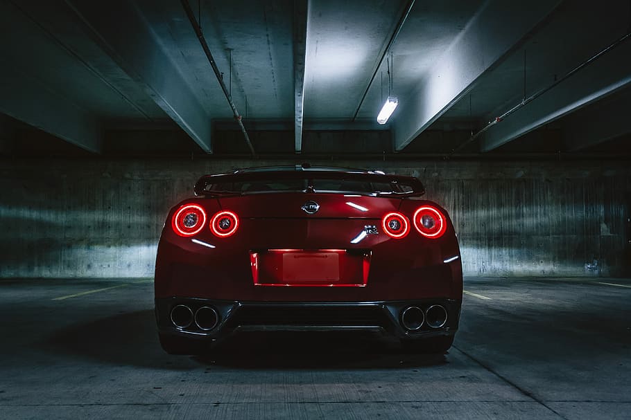 red sports car on concrete flooring, closeup photography of red Nissan GT-R R35 Nismo's rear inside garage, HD wallpaper