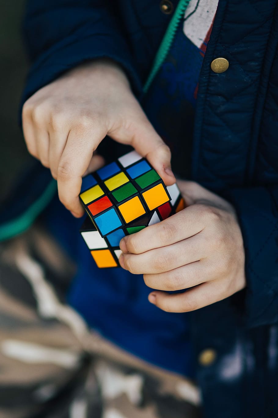 Boy in a blue jacket holding things, man, ball, rubik's cube HD wallpaper