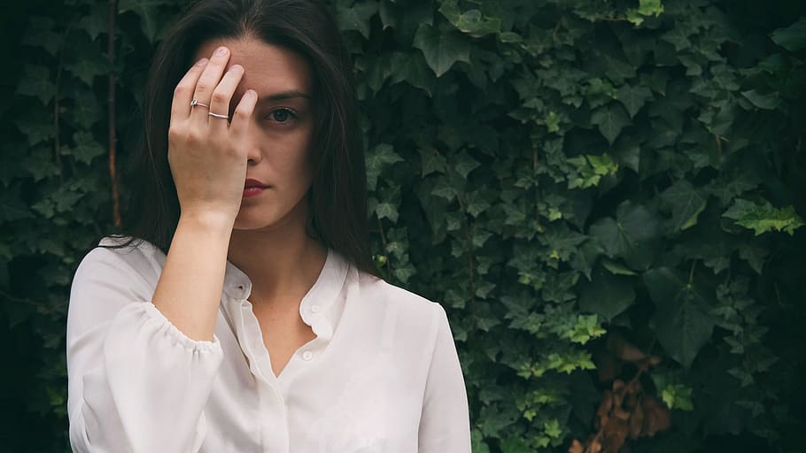 woman wearing white button-up top in front of green leafed plant HD wallpaper