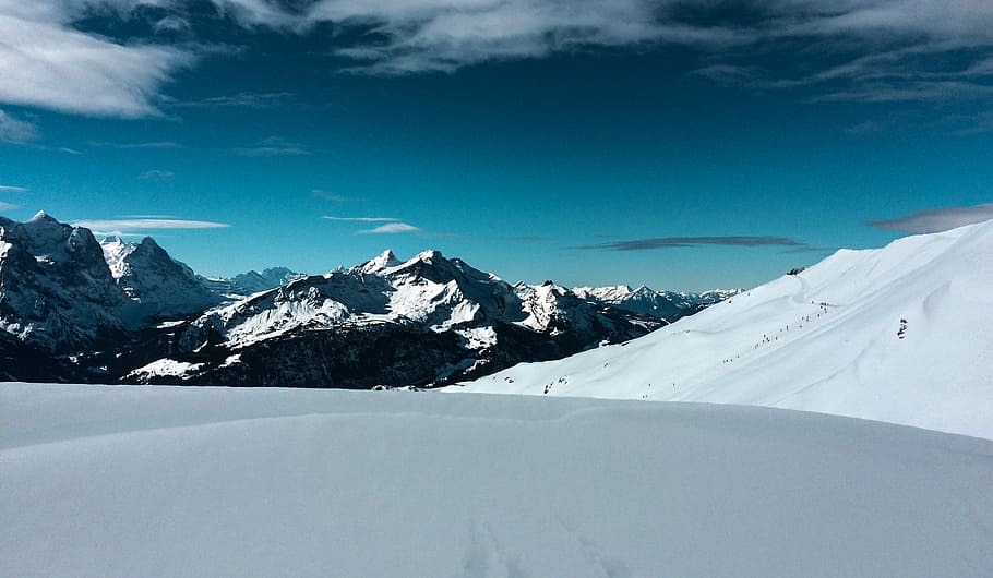 snow field during daytime, snow covered mountains under white clouds and blue sky HD wallpaper