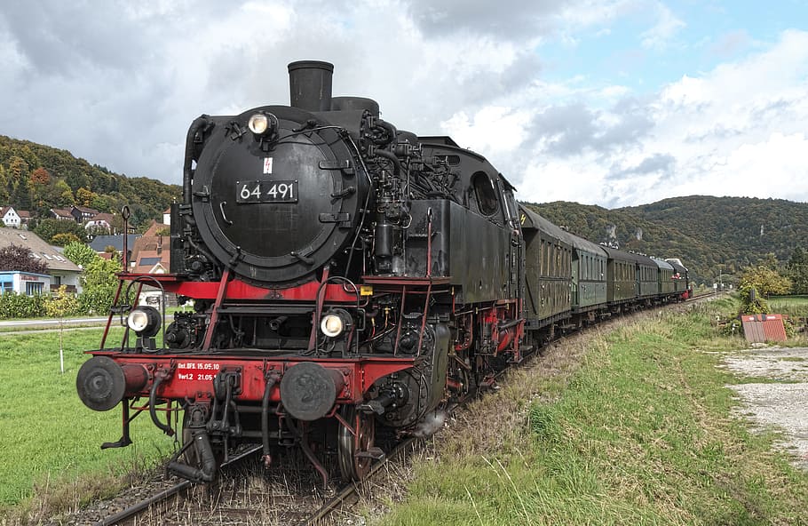 black and red steam-engine train under cloudy sky, steam locomotive