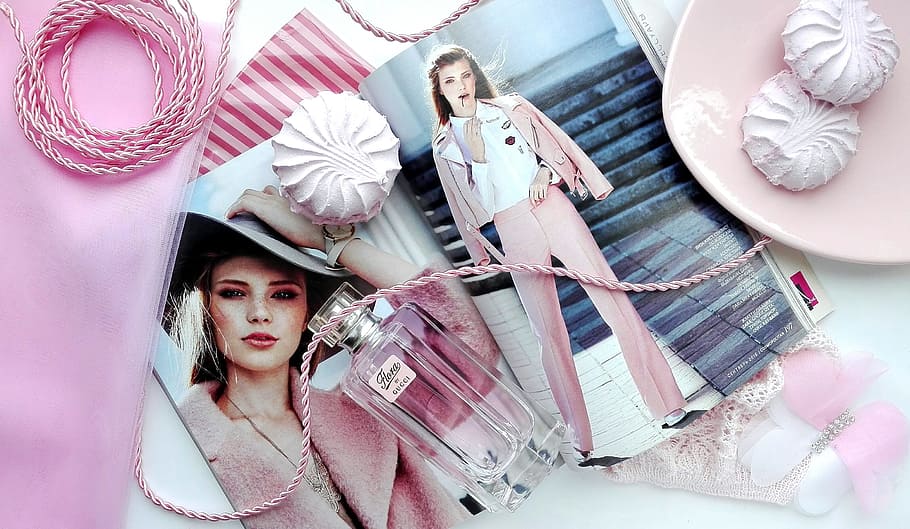 perfume bottle with woman's photo beside pink plate, magazine HD wallpaper