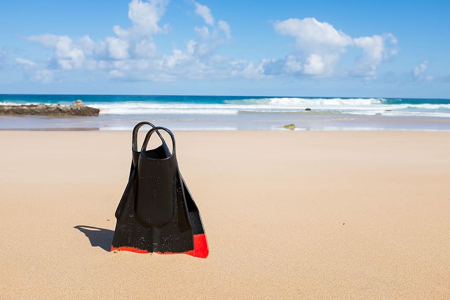 pair of black-and-red flippers on seashore during daytime, beach HD wallpaper
