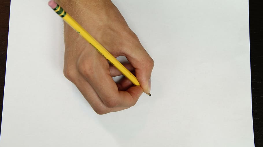 person holding yellow pencil on white paper, hand, writing HD wallpaper