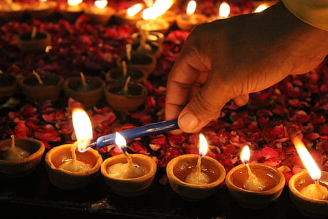 person lighting candles, lamp, bright, design, bulb, glow, dark HD wallpaper