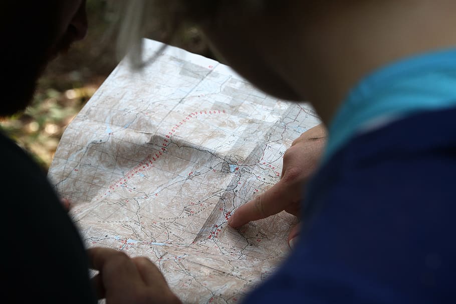 person holding world map, finger, pointing, directions, navigation HD wallpaper