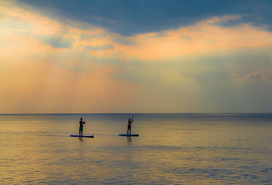 two people on paddle boards, sunset, water, dawn, dusk, silhouetted HD wallpaper