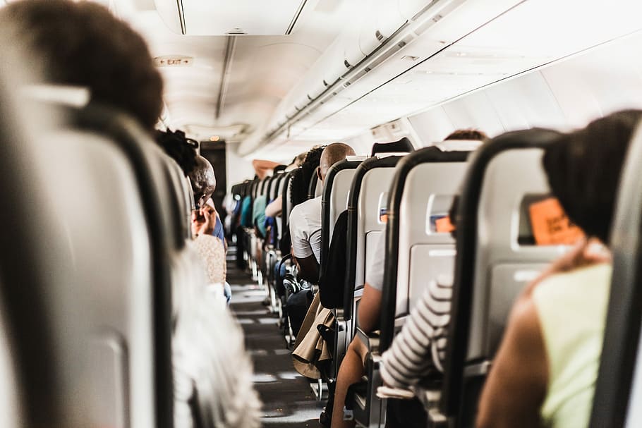 people seating in vehicle, people sitting inside the plane, airplane