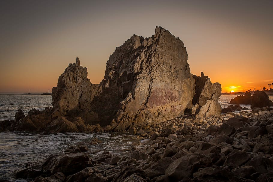 brown rock formation, brown rocks near shore, mountain, sunset HD wallpaper