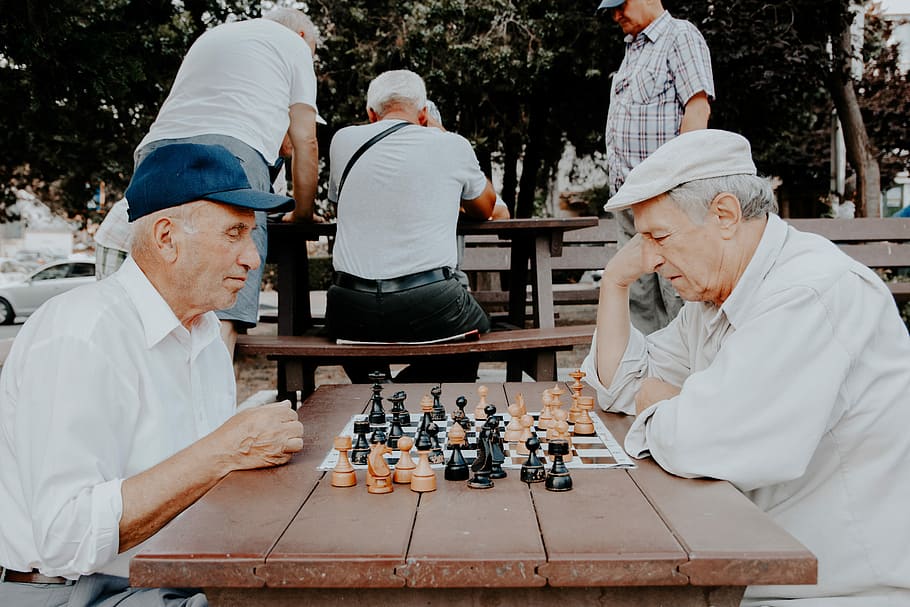 two men playing chess, two grandfather playing chess on table