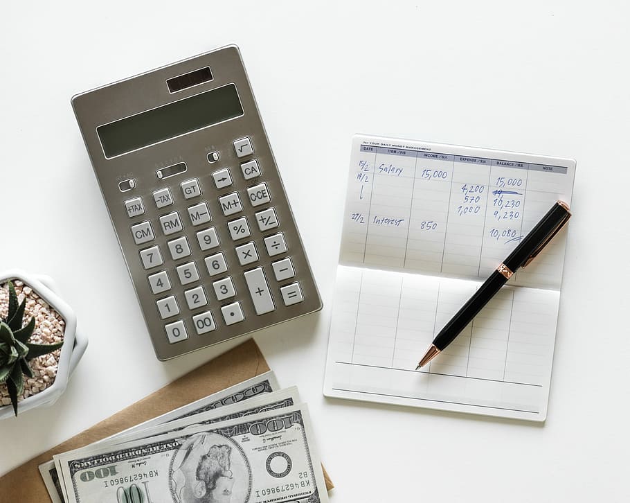 gray desk calculator beside black twist pen, white background HD wallpaper