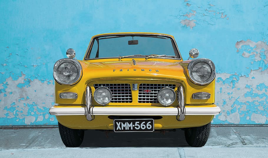 classic yellow car parked near teal wall, triumph, old car HD wallpaper