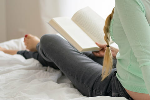 woman sitting on bed while reading book, bedroom, pillow, comforter HD wallpaper