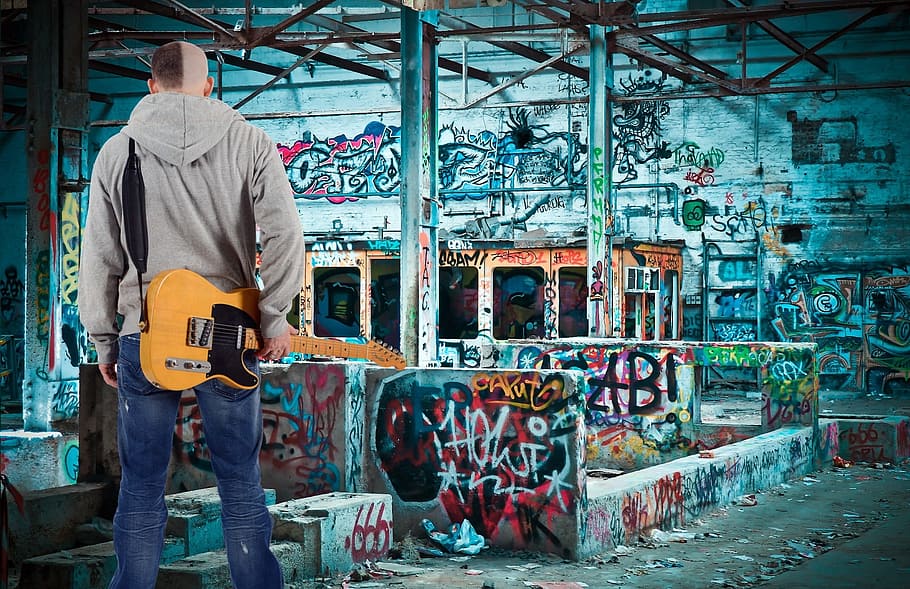 man holding yellow electric guitar, young, boy, musician, graffiti