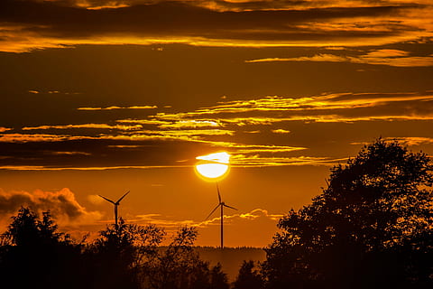two windmill turbines under clouds golden hour photography HD wallpaper