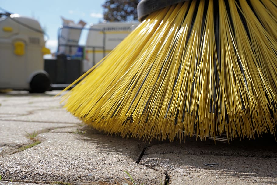close-up photography of yellow floor brush, sweeper, periodic brush