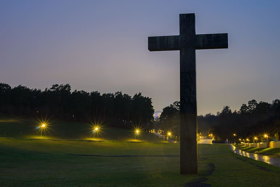 Brown Cross Statue on Green Grass Field With Turned on Light during Nighttime HD wallpaper