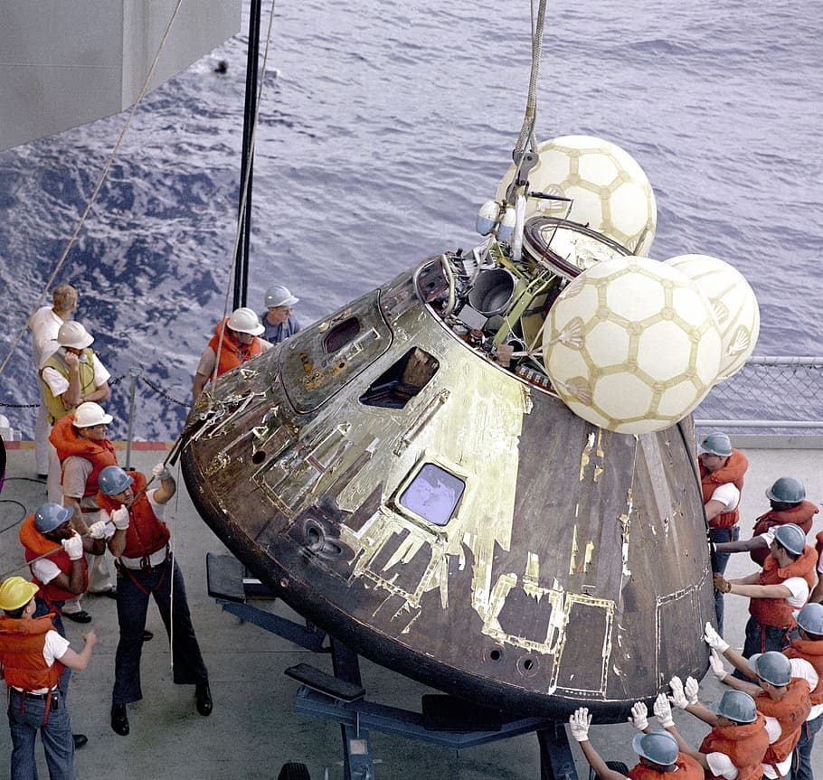 people surrounding the astronaut, apollo 13, landing module, landing capsule