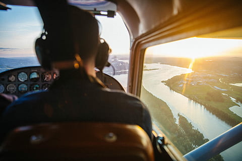 view of helicopter cockpit on top of river, man inside of plane and showing river during daytime HD wallpaper