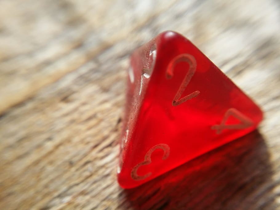 close-up photography of triangle red dice on brown wooden surface HD wallpaper
