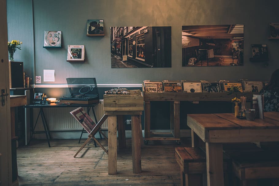brown wooden dining table inside room, brown wooden table filled with vinyl records, HD wallpaper