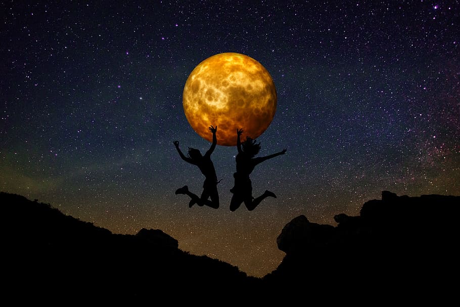 two silhouette persons jumping on cliff with moon background HD wallpaper