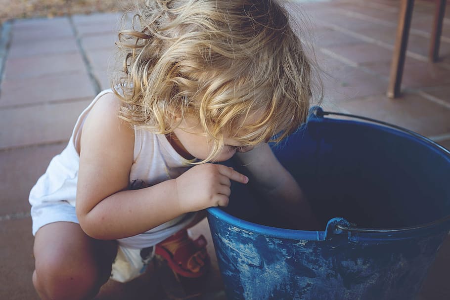 toddler looking in bucket, blue, playing, child, baby, small