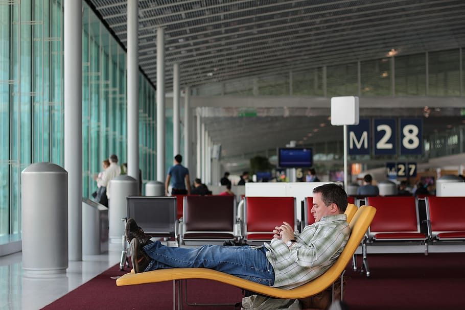 man sitting on airport waiting area, man siting on airport lounge
