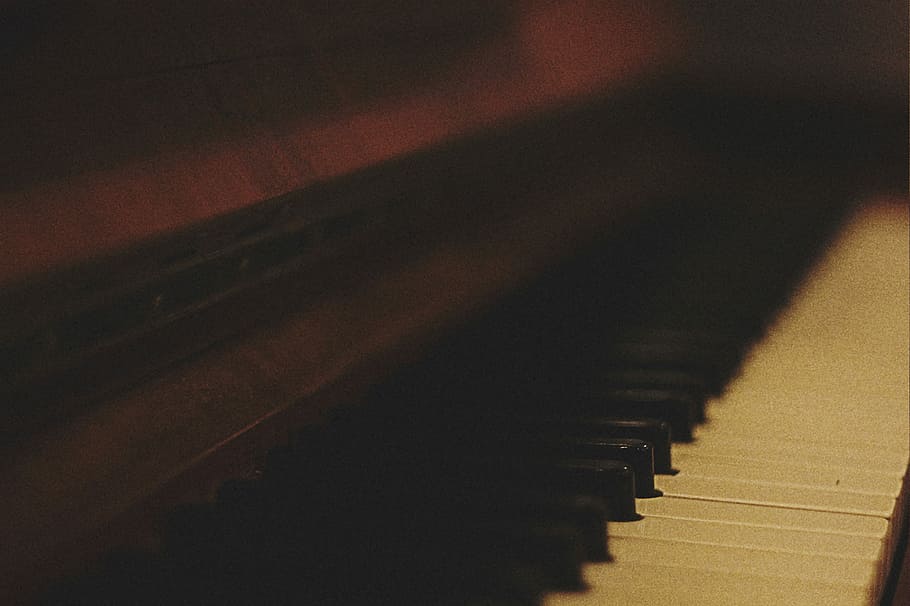 brown upright piano, selective focus photography of piano keys