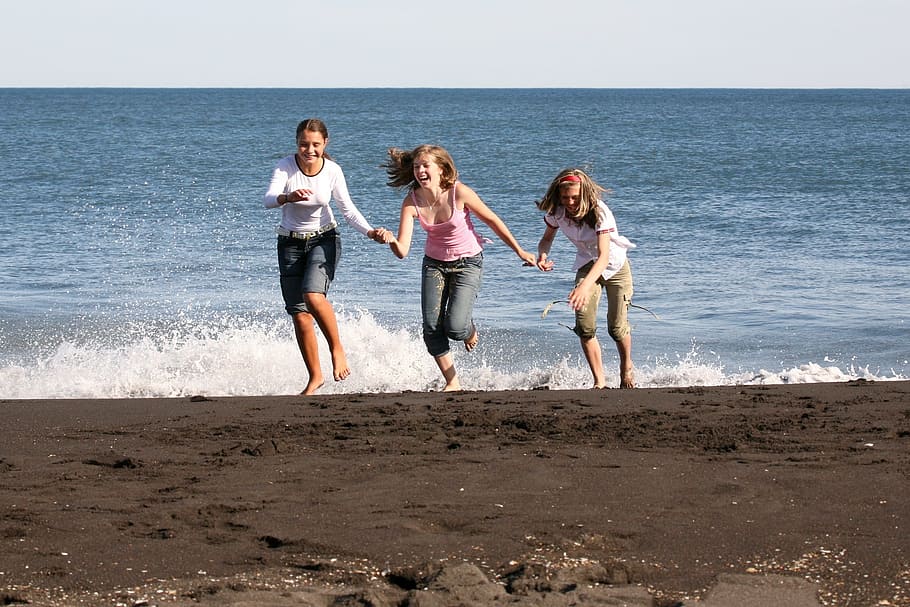 three girls running away from ocean wave on the beach, sky HD wallpaper