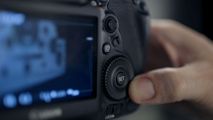 person holding gray digital camera, focus photography on black DSLR camera HD wallpaper