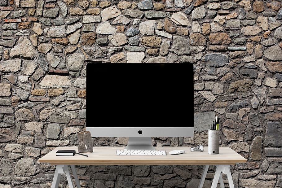 silver iMac on top of white wooden table, poster, mockup, interior